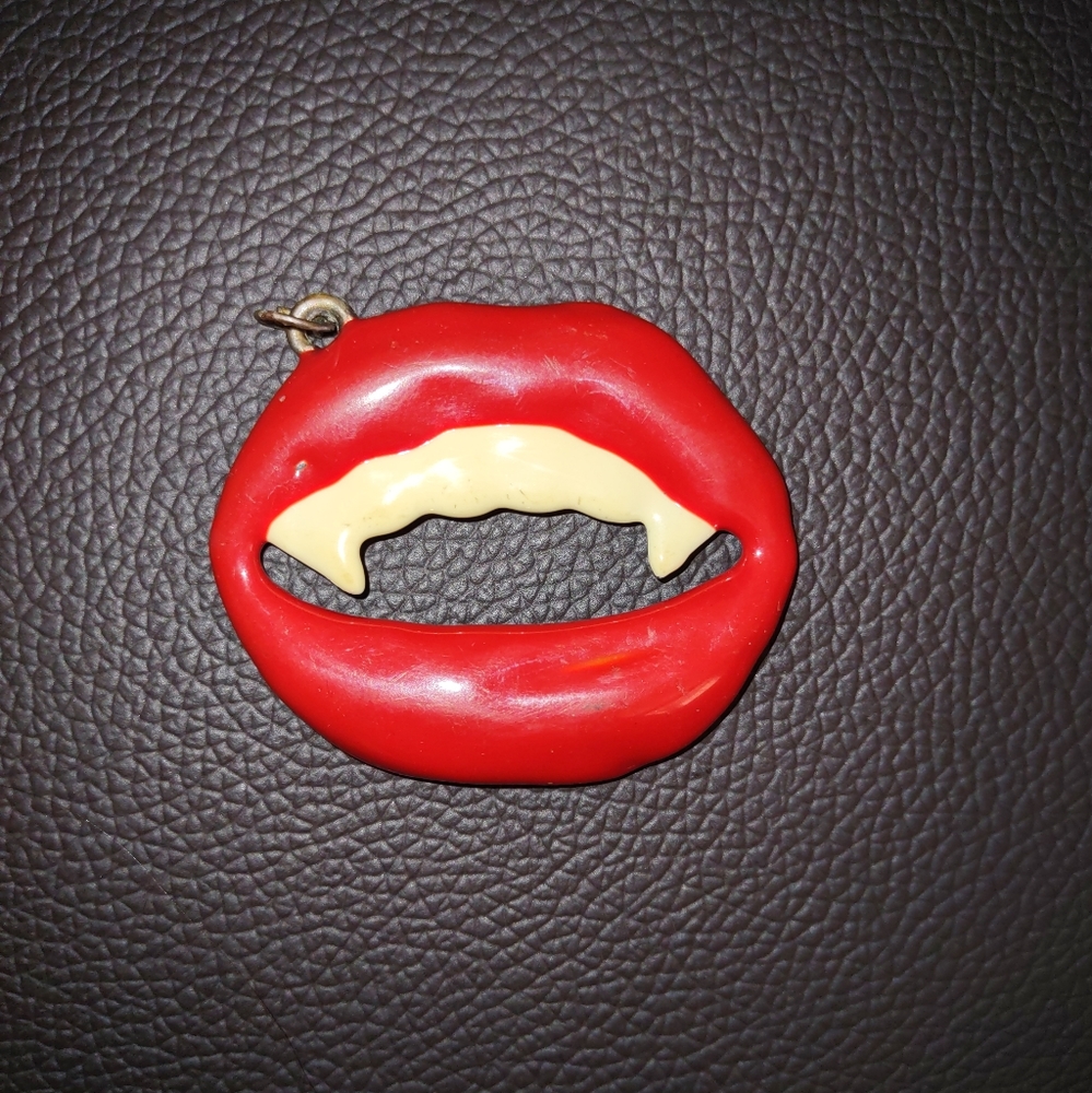 Vintage metal vampire smile pendant